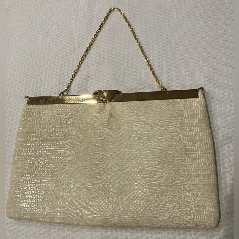 Vintage Etra cream embossed clutch with a gold frame and chain.